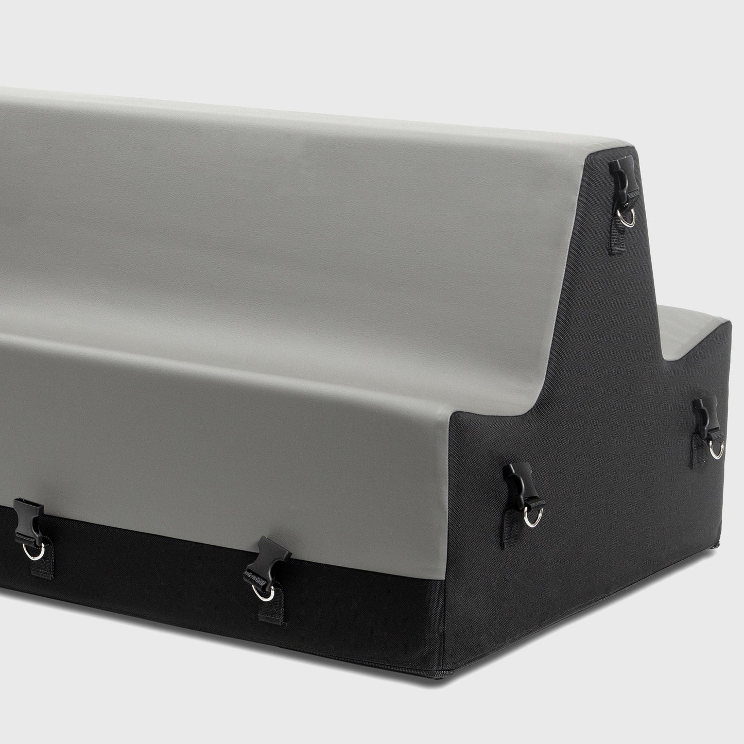 A grey and black Steed Spanking Bench bedroom furniture by Liberator with cuffs against a white background showing the connectors where the cuffs attach.