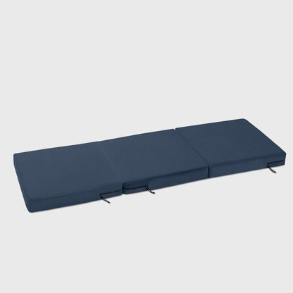 An Ink Blue Center Stage ottoman, Bedroom Furniture by Liberator unfolded against a white background.